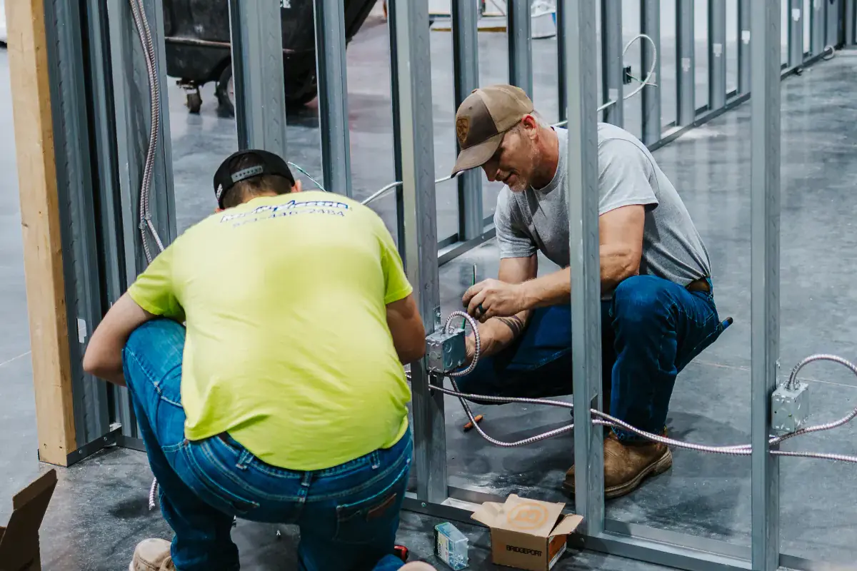 Two Midway Electric electricians wiring a project in Columbia, MO