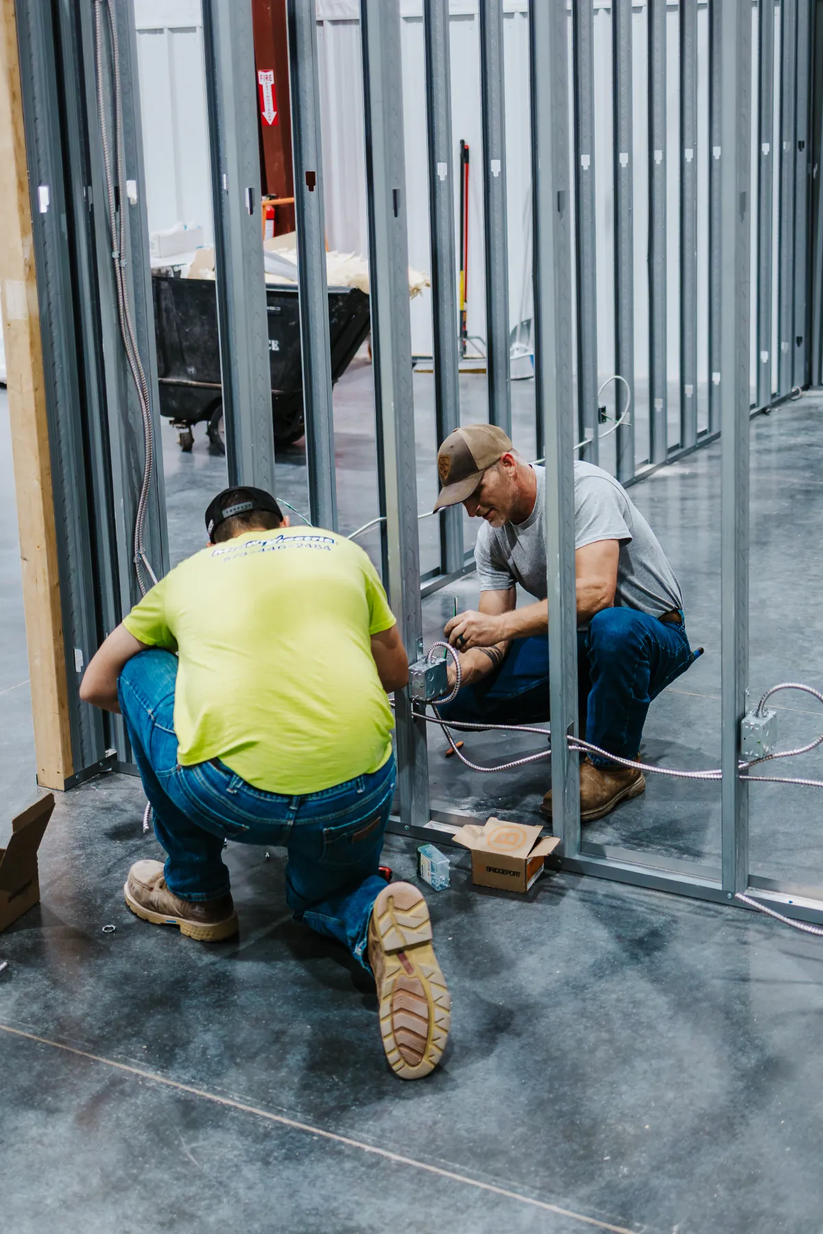 Two Midway Electric electricians wiring a project in Columbia, MO