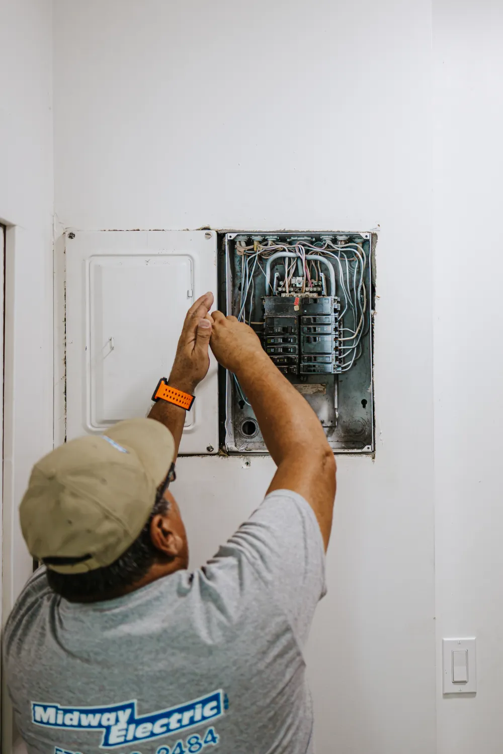 A Midway Electric electrician working on a home electrical panel in Columbia, MO