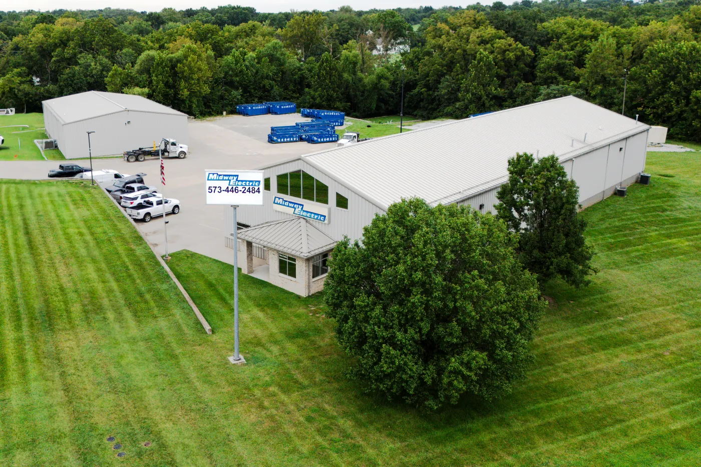 Aerial view of the Midway Electric shop, sign, and service fleet in Columbia, Missouri